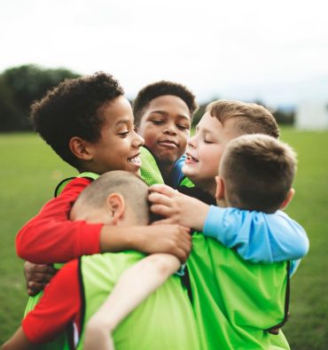 junior-football-team-hugging-each-other_53876-137683